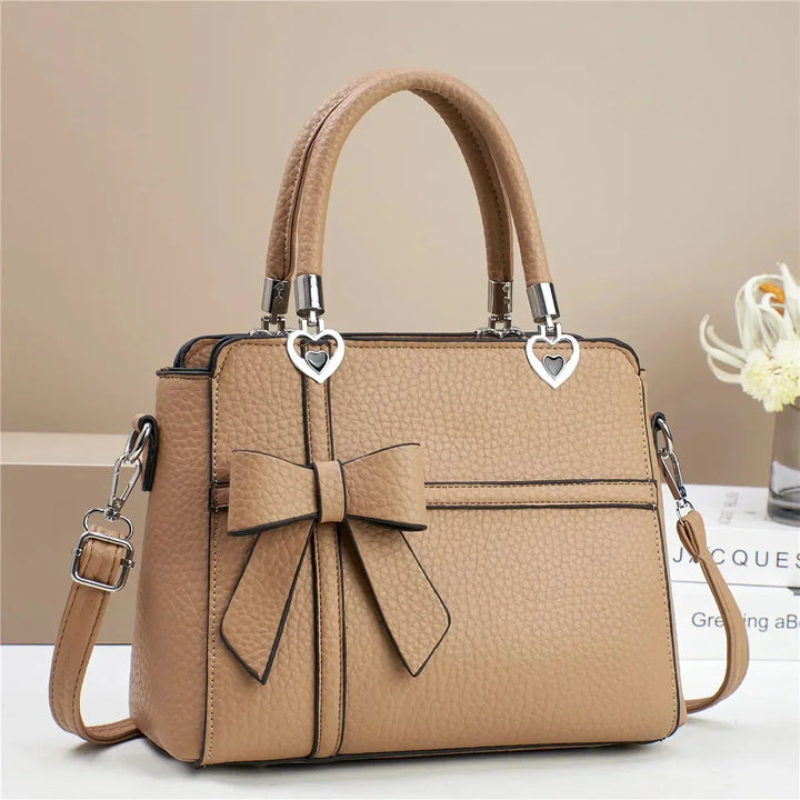 Gabriela | Women’s bow handbag with heart accents