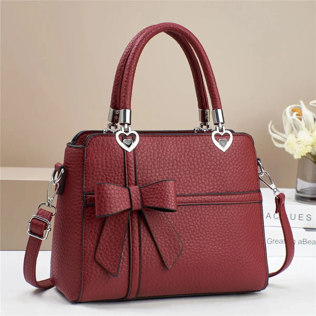 Gabriela | Women’s bow handbag with heart accents