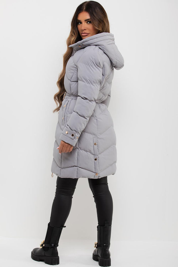 Avelina | Women’s long puffer coat with belt and gold button detail